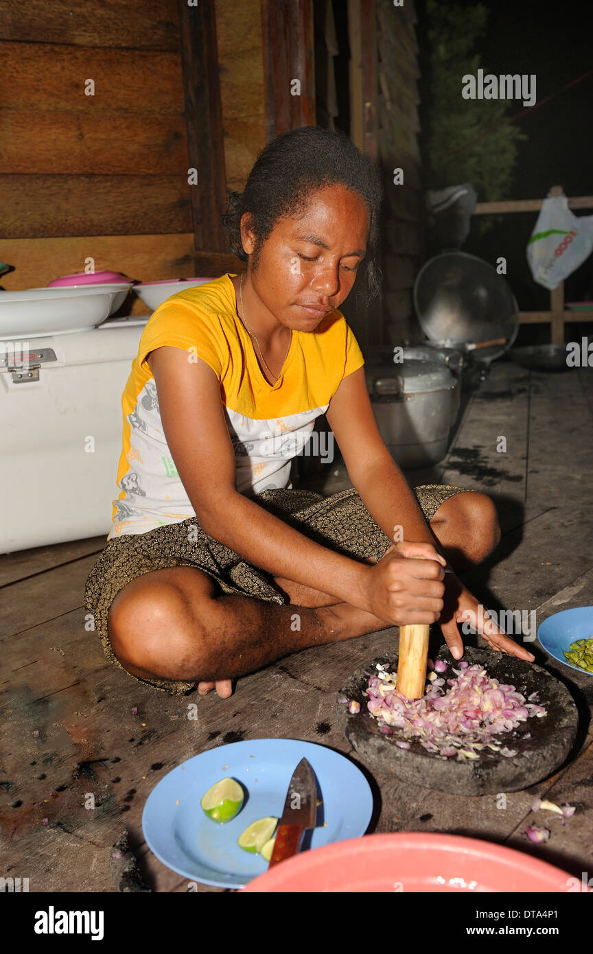 Papuan woman preparing food, Runi Island, Biak, West Papua, Indonesia Stock Photo