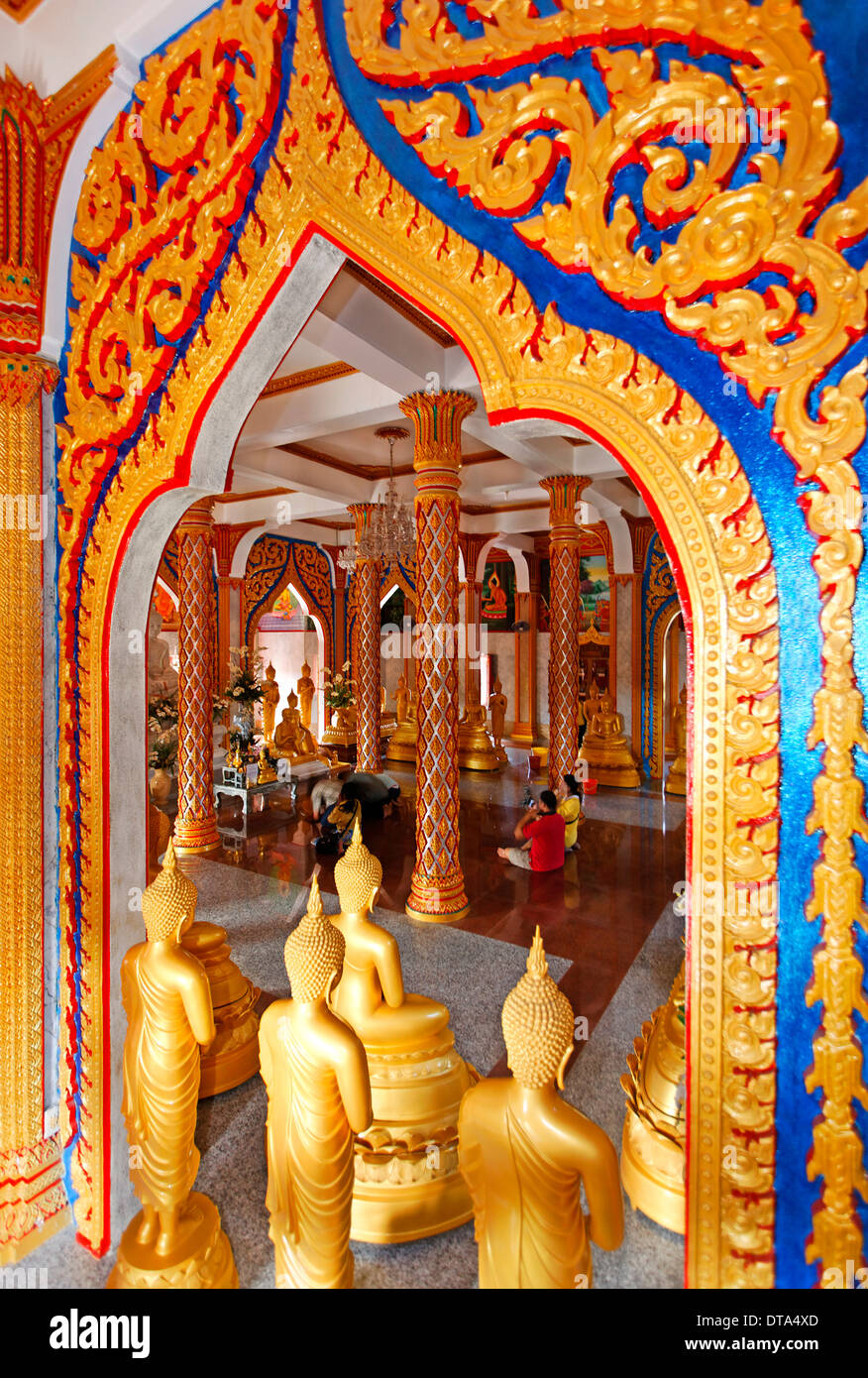 Ornate gate and golden Buddha statues, Wat Chalong temple, Phuket, Thailand Stock Photo