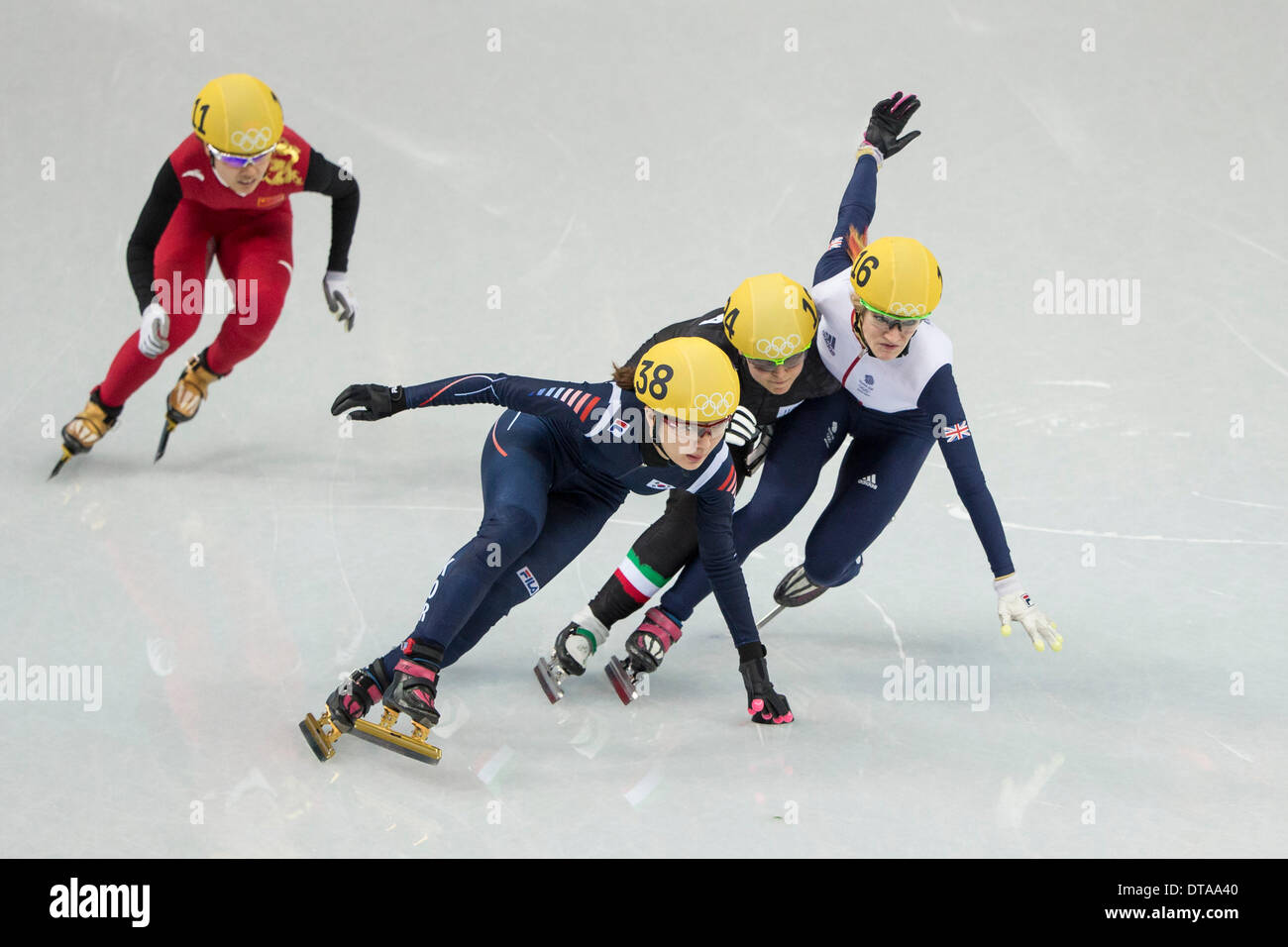 Sochi, Russia. 13th Feb, 2014.  Elise CHRISTIE (116, GBR) tries to squeeze down the inside on the first lap, goes the wrong side of a marker, takes out Arianna FONTANA (124, ITA) while Park SEUNG-HI (138, KOR) also falls on the exit of the turn. CHRISTIE is later penalised for same, thus missing out on a medal - during the final of the Women's 500m Short Track Speed Skating competition at the Iceberg Skating Palace, Coastal Cluster - XXII Olympic Winter Games © Action Plus Sports Images/Alamy Live News Credit:  Action Plus Sports/Alamy Live News Stock Photo