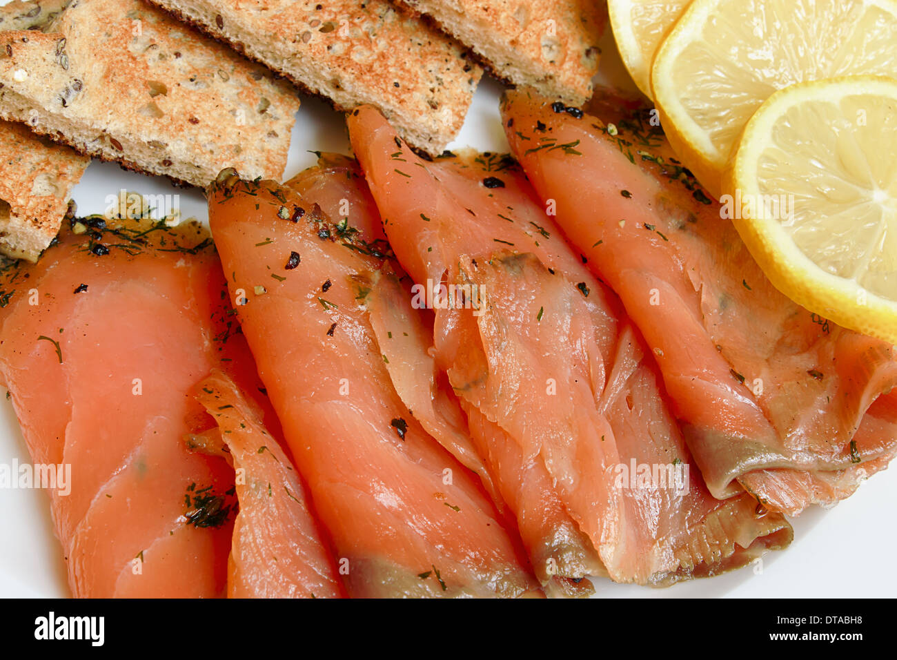 Smoked salmon sliced and arranged with toast a popular appetizer Stock Photo