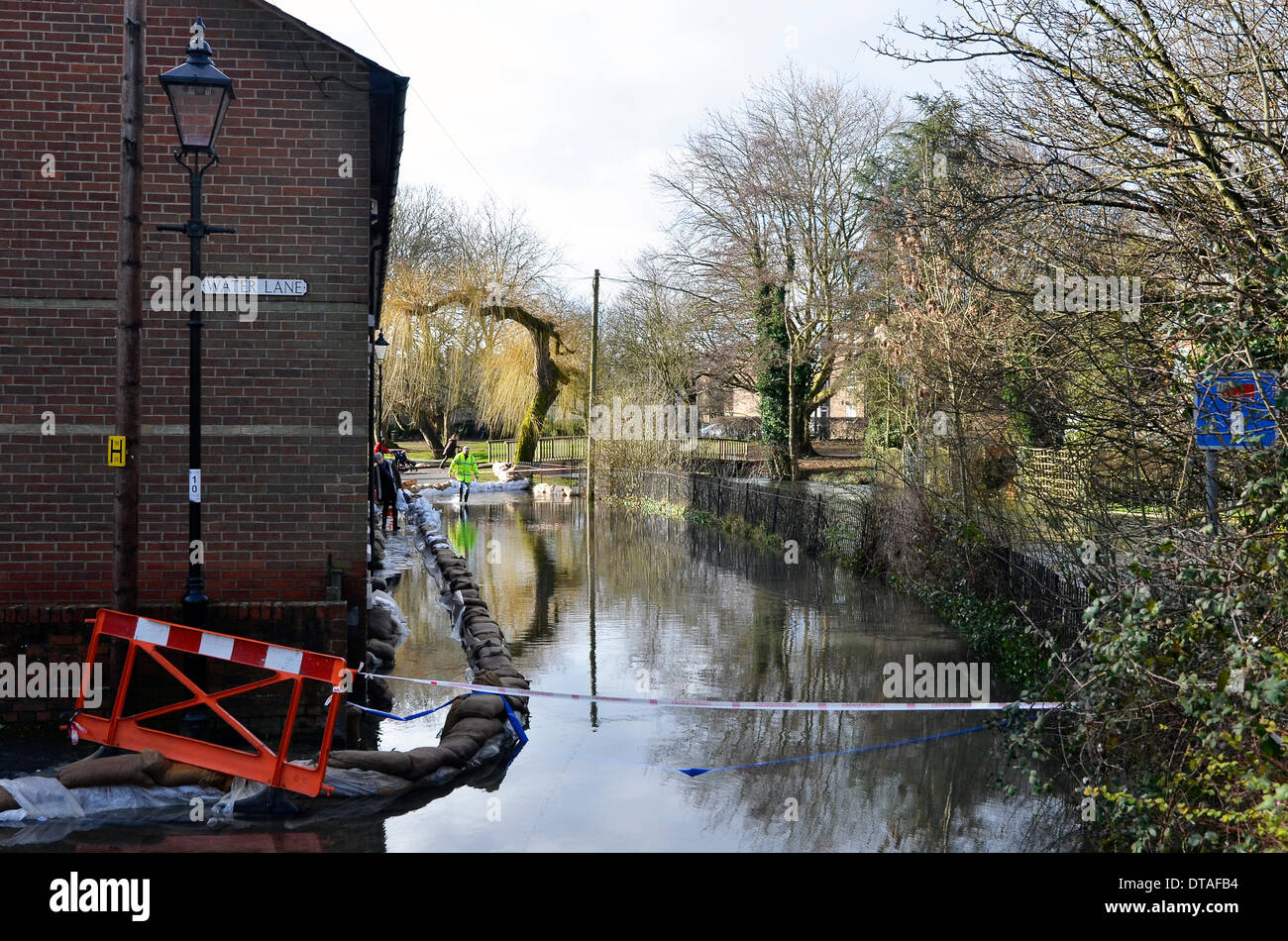The River Itchen overflows along Water Lane close to the city centre of Winchester, the county town of Hampshire. Navy personnel  have erected sandbag bunds in an attempt to contain the water and prevent the flooding of property. Stock Photo