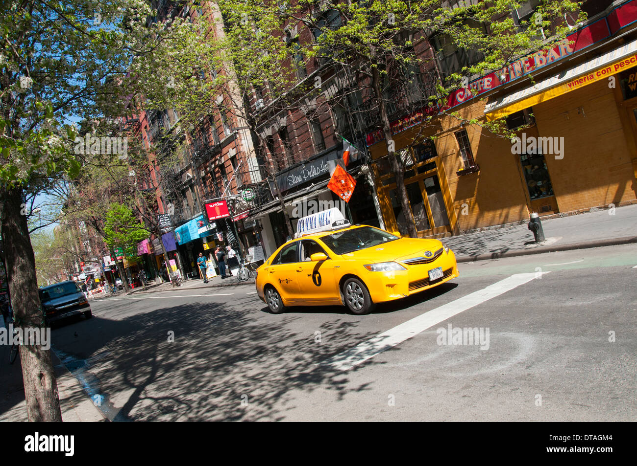 A yellow cab driving through Greenwich Village in Manhattan New York City, USA Stock Photo