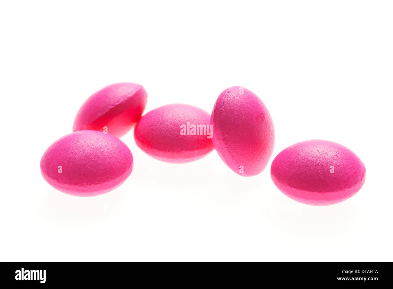Pink round ibuprofen 200mg tablets on a white background Stock Photo