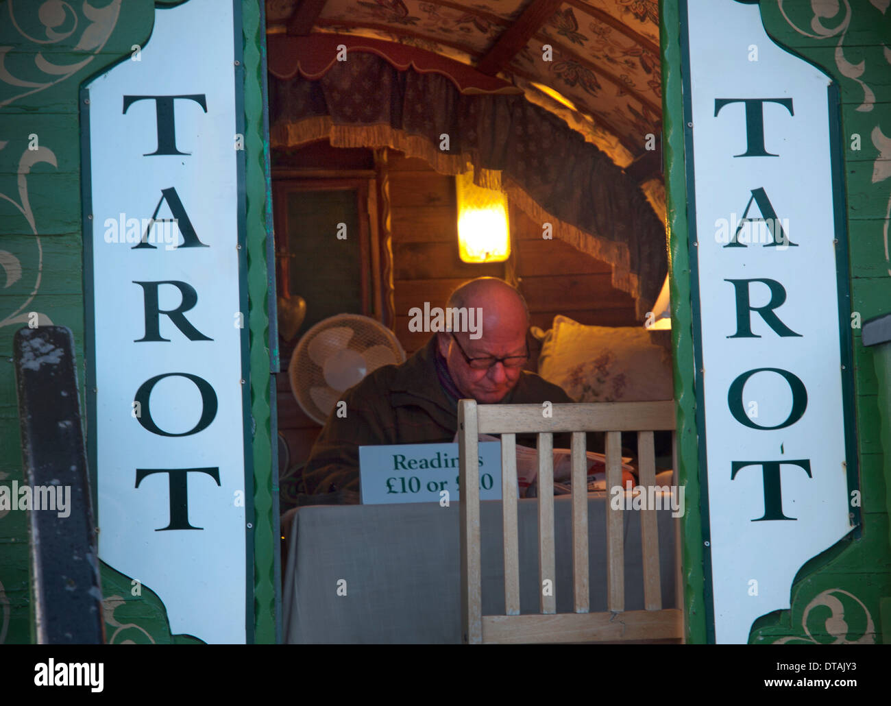 A reader of tarot cards at work in his caravan on Brighton Pier Stock Photo