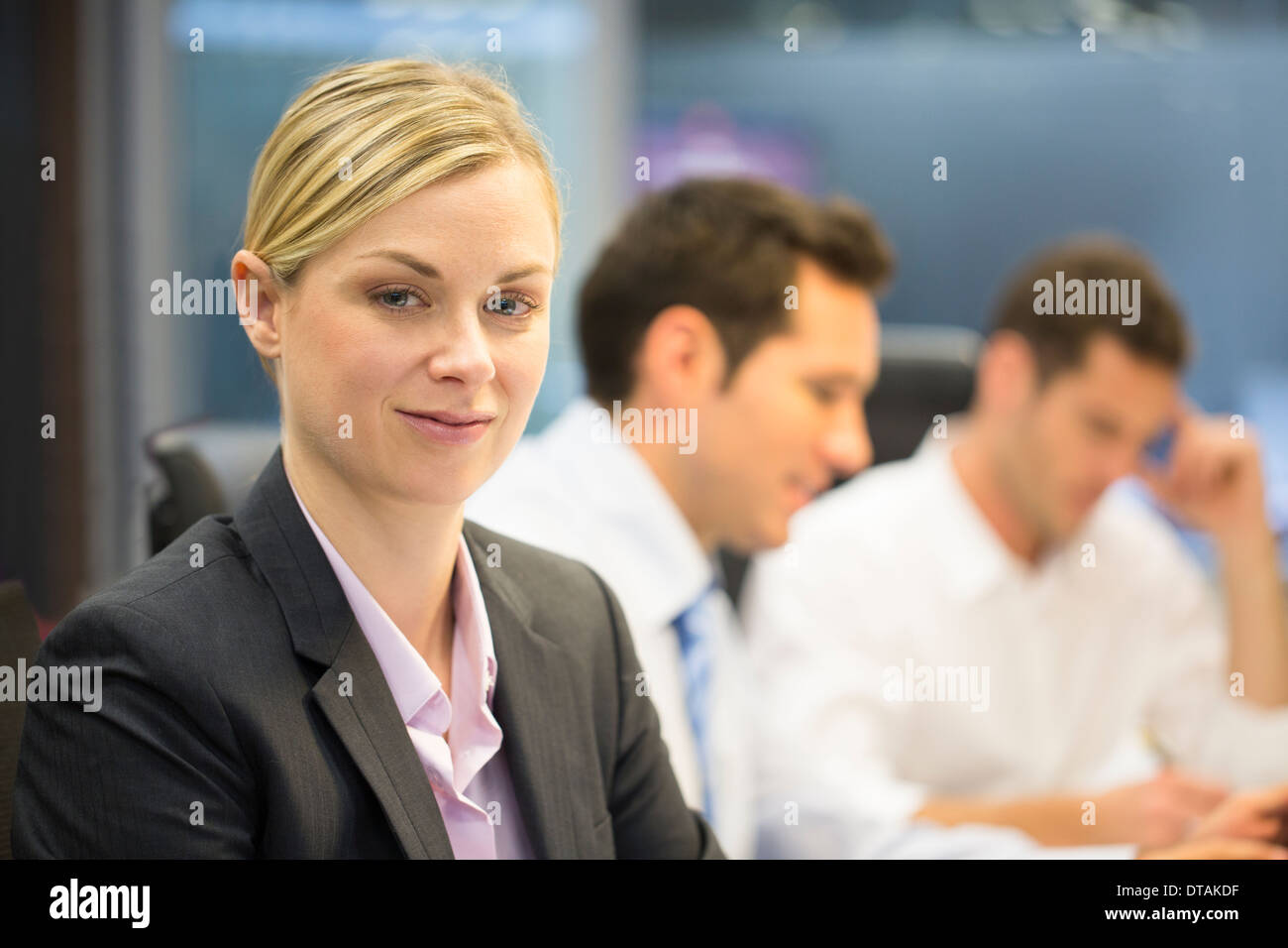 Portrait of a businesswoman smiling in a meeting, looking camera Stock Photo