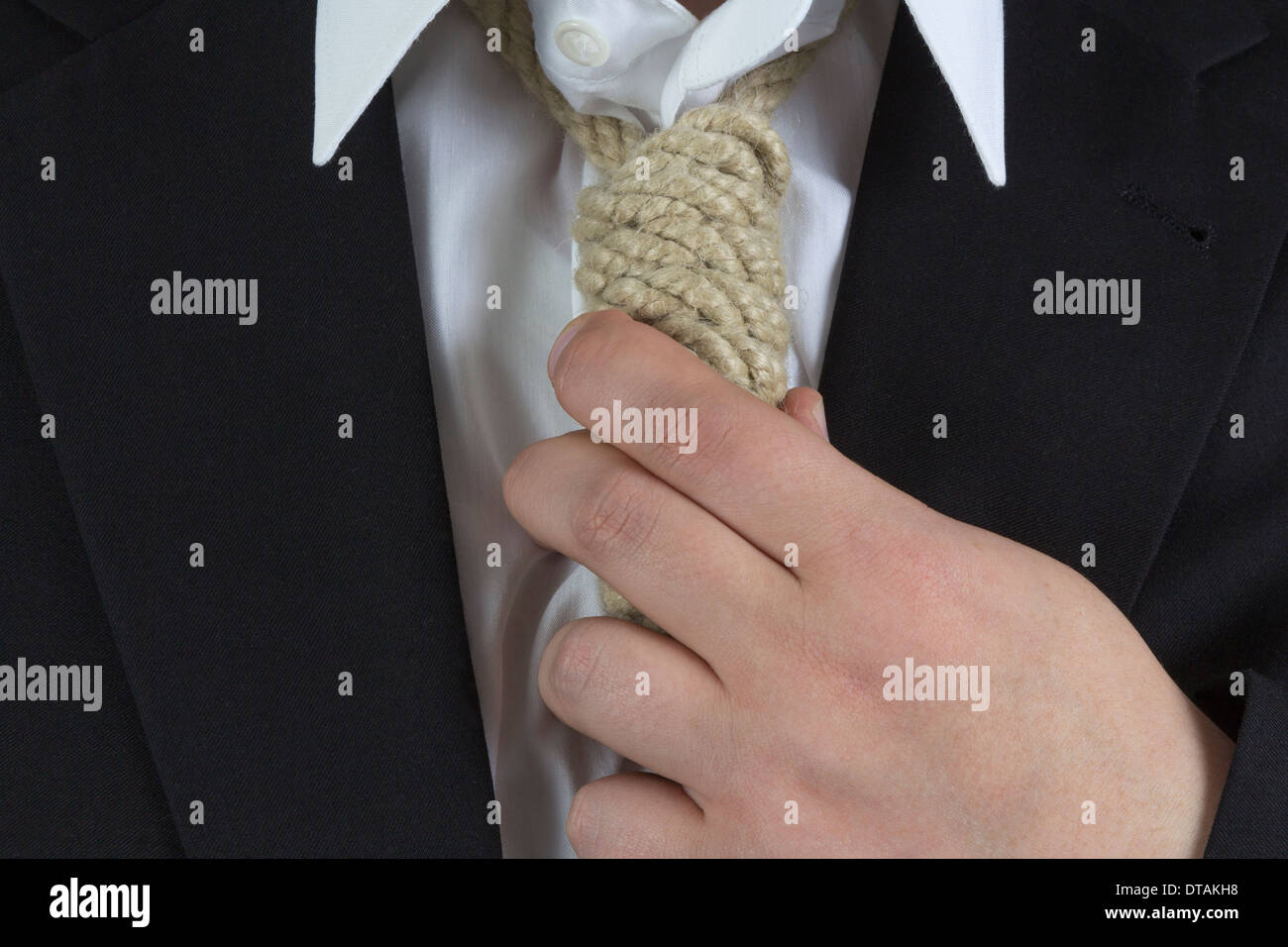 Businessman wearing a hangman's noose instead of a tie around the neck Stock Photo