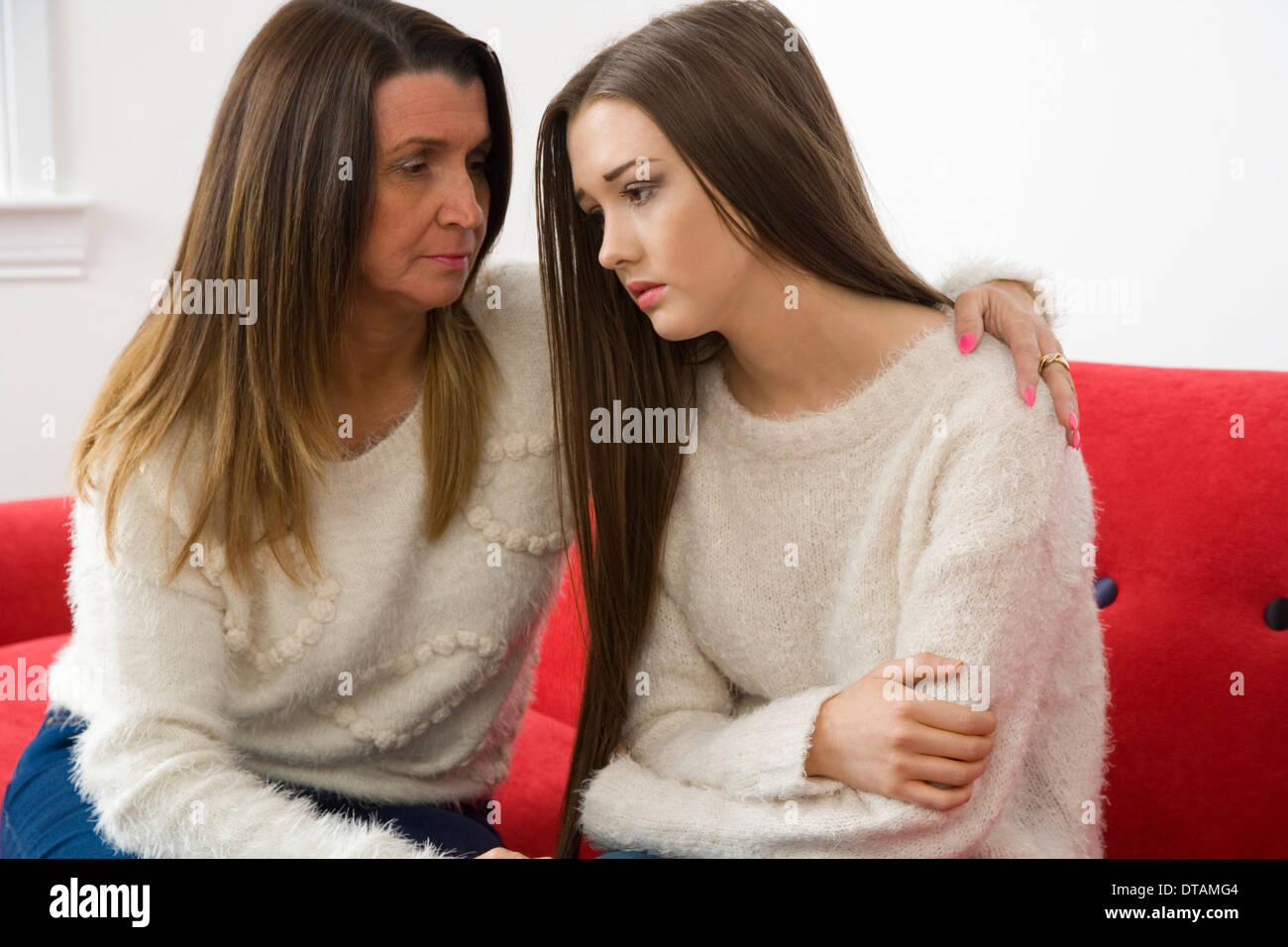Mother comforting her sad teenage daughter. Stock Photo