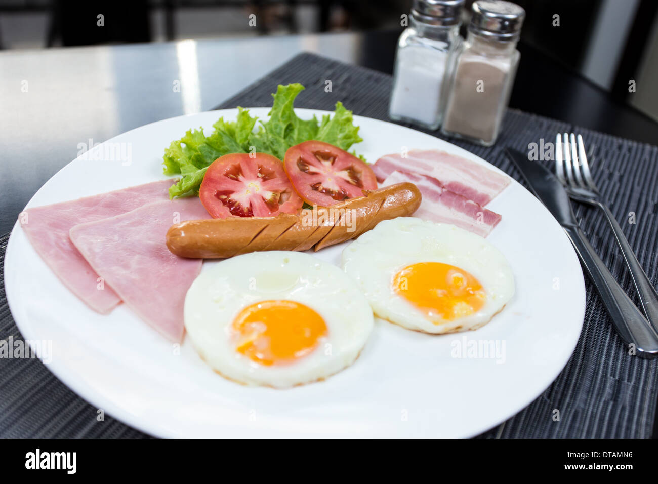 American breakfast with eggs ham bacon and sausage Stock Photo