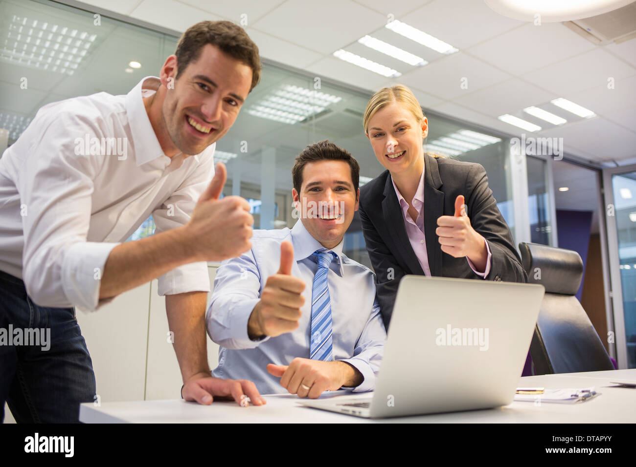 Happy business team in a office celebrating a success, looking camera Stock Photo