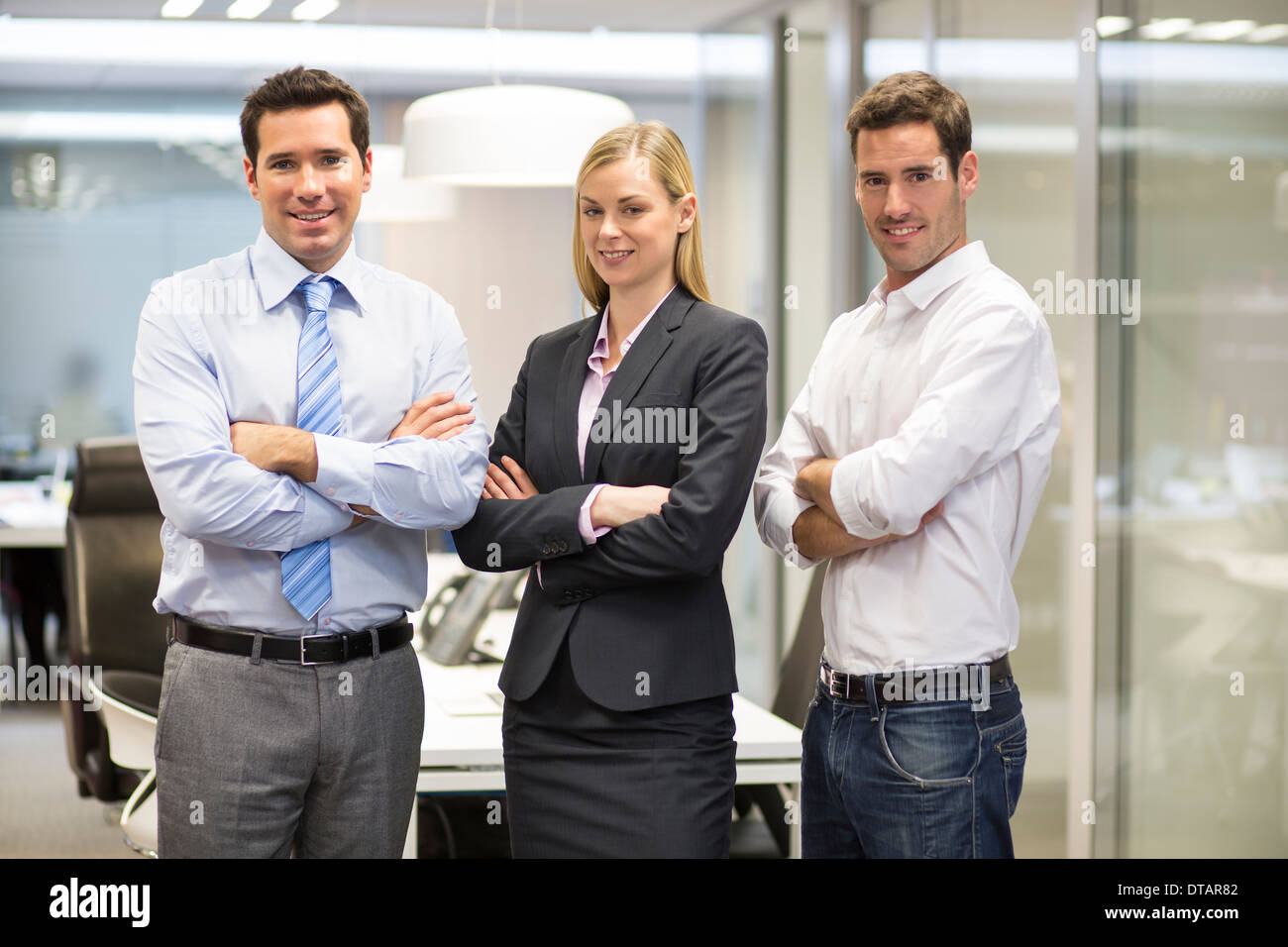 Portrait of smiling business team in office, looking camera Stock Photo
