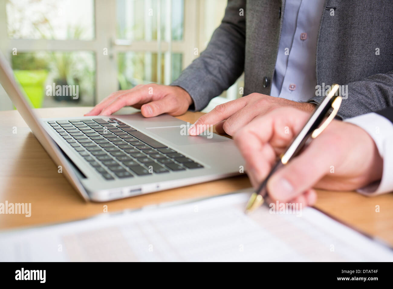 Closeup of Two hands businessmen working together in office with laptop Stock Photo