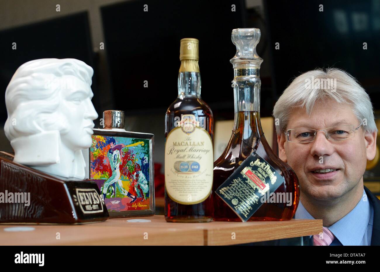 Bietigheim-Bissingen, Germany. 09th Feb, 2014. Auctioneer Christoph Gaertner is pictured in next to whisky bottles in a storage room of his auction house in Bietigheim-Bissingen, Germany, 09 February 2014. The model is part of the biggest private collection of whisky bottles in Europe, by his own account. The collection will be auctioned off on 14 February. The about 2600 bottles and unusual containers partly contain extremely rare whisky brands. Photo: BERND WEIßBROD/dpa/Alamy Live News Stock Photo