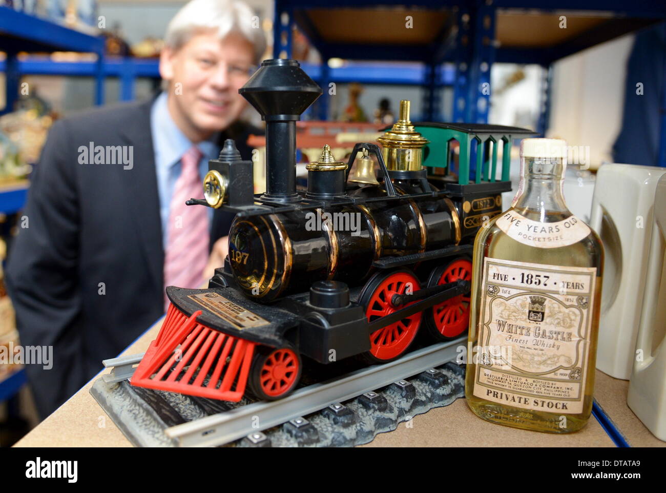 Bietigheim-Bissingen, Germany. 09th Feb, 2014. Auctioneer Christoph Gaertner is pictured in front of a model train filled with whisky in a storage room of his auction house in Bietigheim-Bissingen, Germany, 09 February 2014. The model is part of the biggest private collection of whisky bottles in Europe, by his own account. The collection will be auctioned off on 14 February. The about 2600 bottles and unusual containers partly contain extremely rare whisky brands. Photo: BERND WEIßBROD/dpa/Alamy Live News Stock Photo