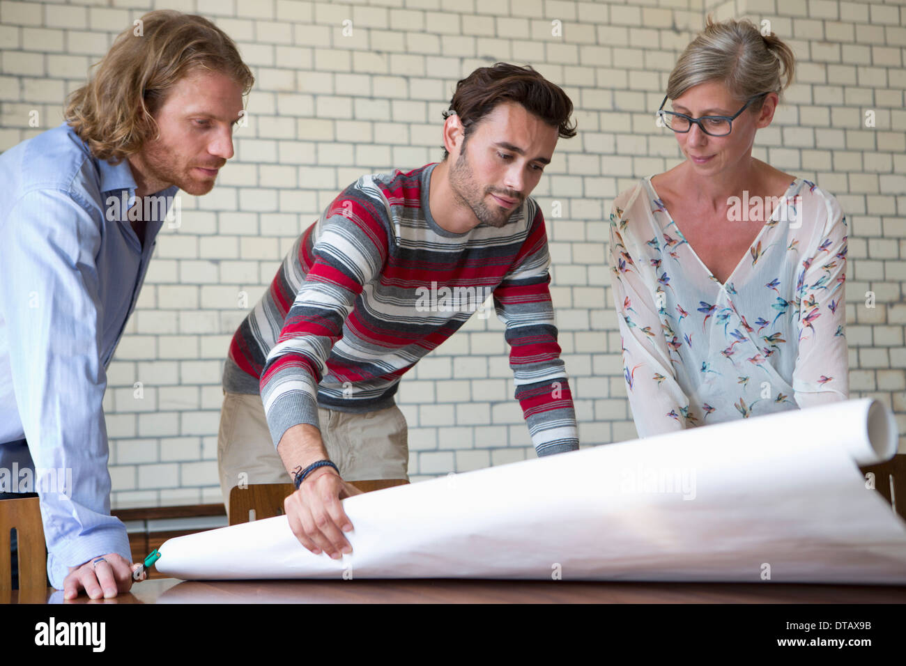 Office colleagues discussing on plan Stock Photo