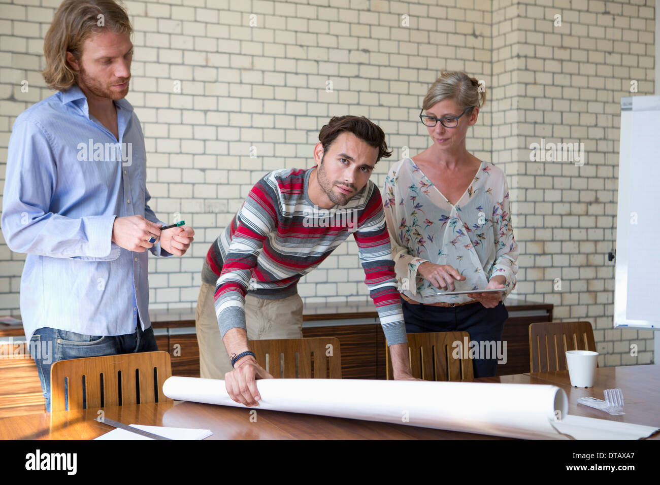 Office colleagues discussing on plan Stock Photo