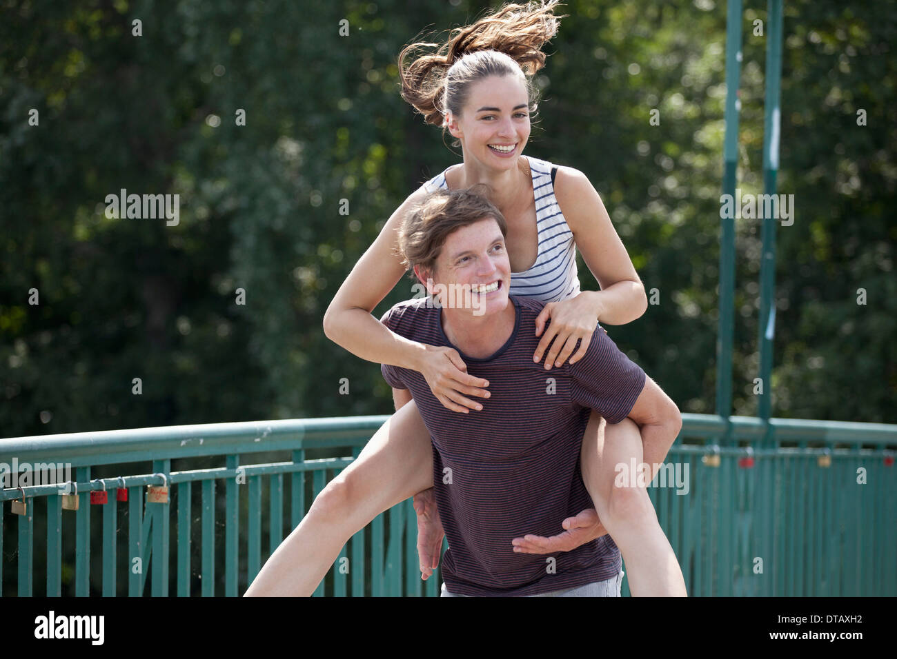 Young man giving woman piggyback ride Stock Photo