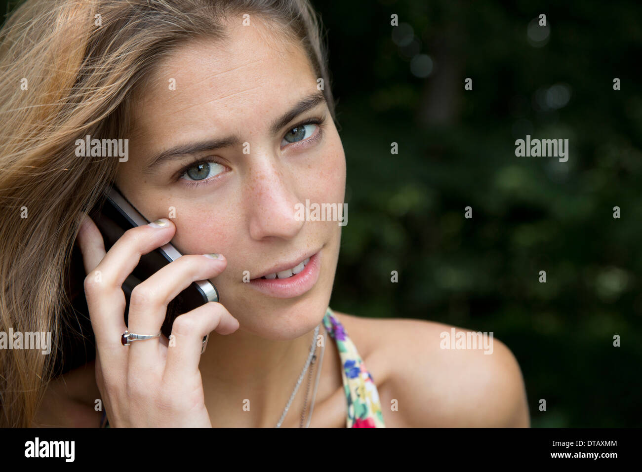 Young woman talking on mobile phone, close-up Stock Photo