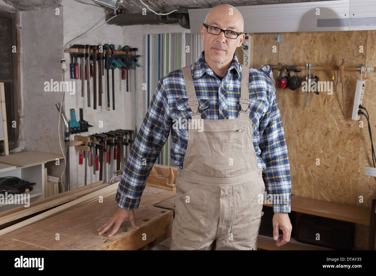 Mature man standing in carpenter shop, portrait Stock Photo