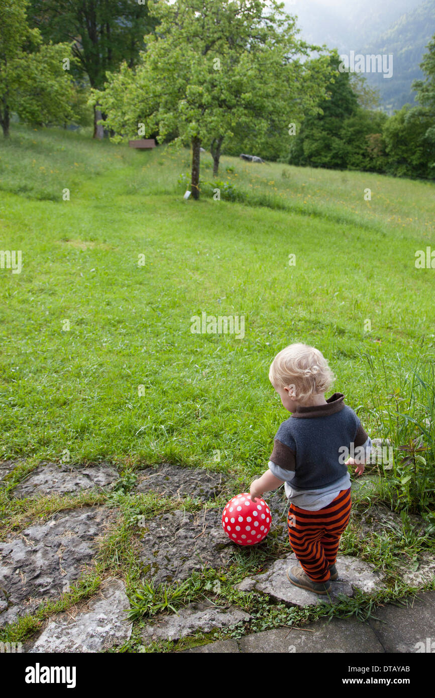 Baby boy playing with ball Stock Photo