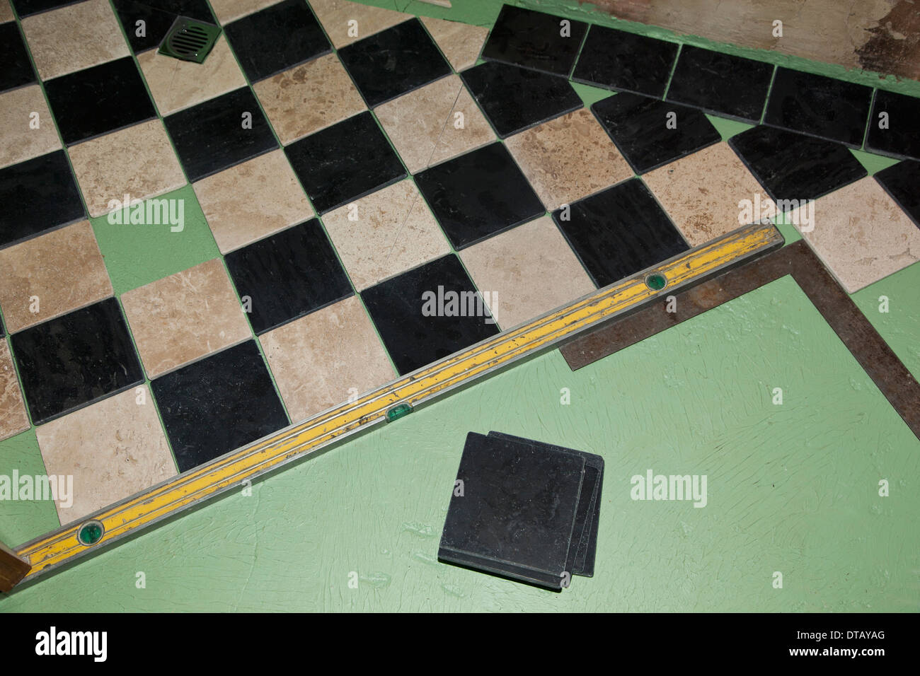 Installing floor tiles Stock Photo