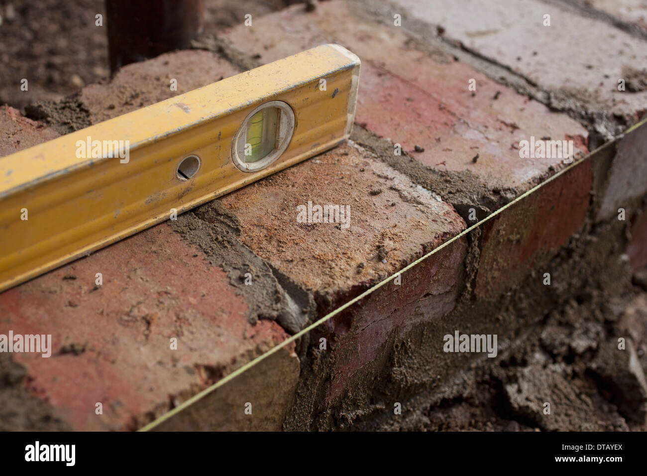 Spirit level on bricks, close-up Stock Photo