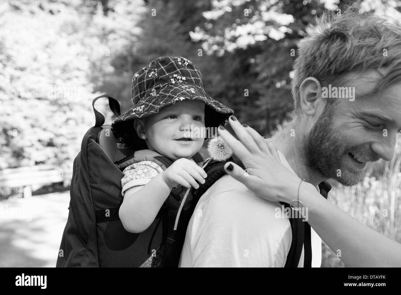 Father carrying his son in baby carrier Stock Photo