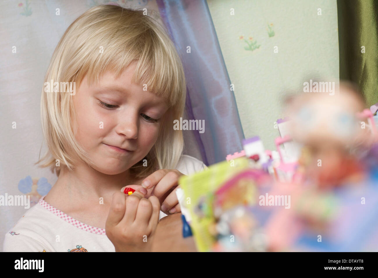 Girl playing with toys Stock Photo Alamy