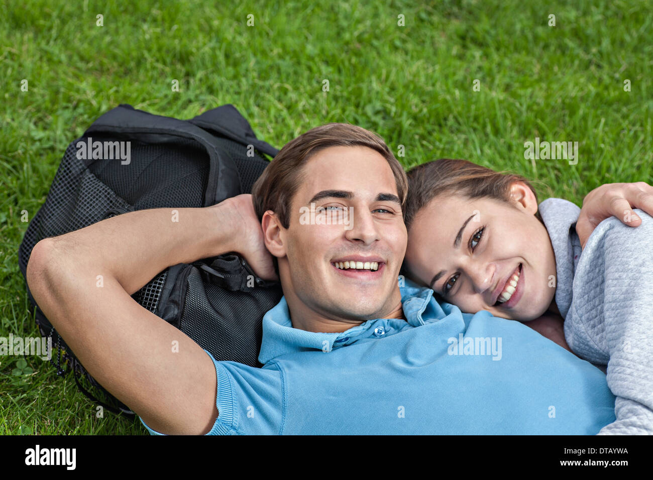 Portrait of young couple lying on grass Stock Photo