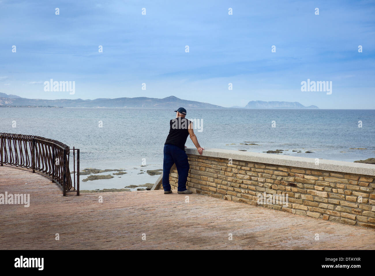 Santa Lucia, Italy, a man stands on the promenade and faces the sea Stock Photo