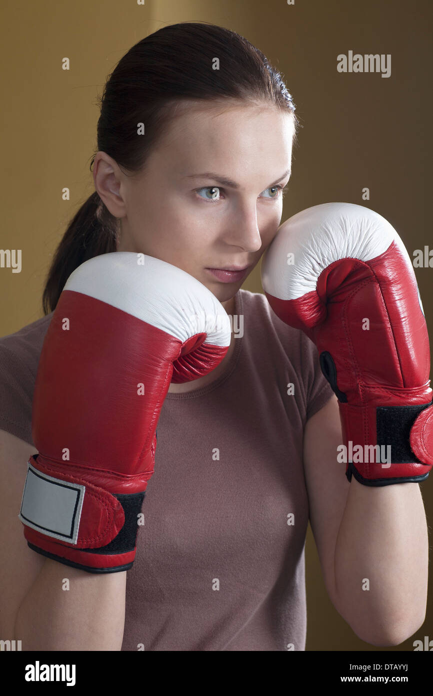 Young woman in boxing glove, looking away Stock Photo