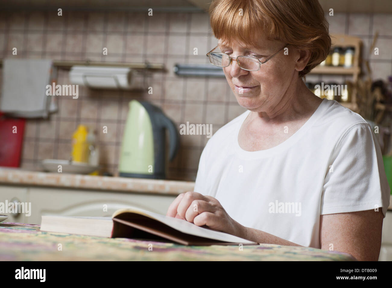 Mature woman reading book Stock Photo