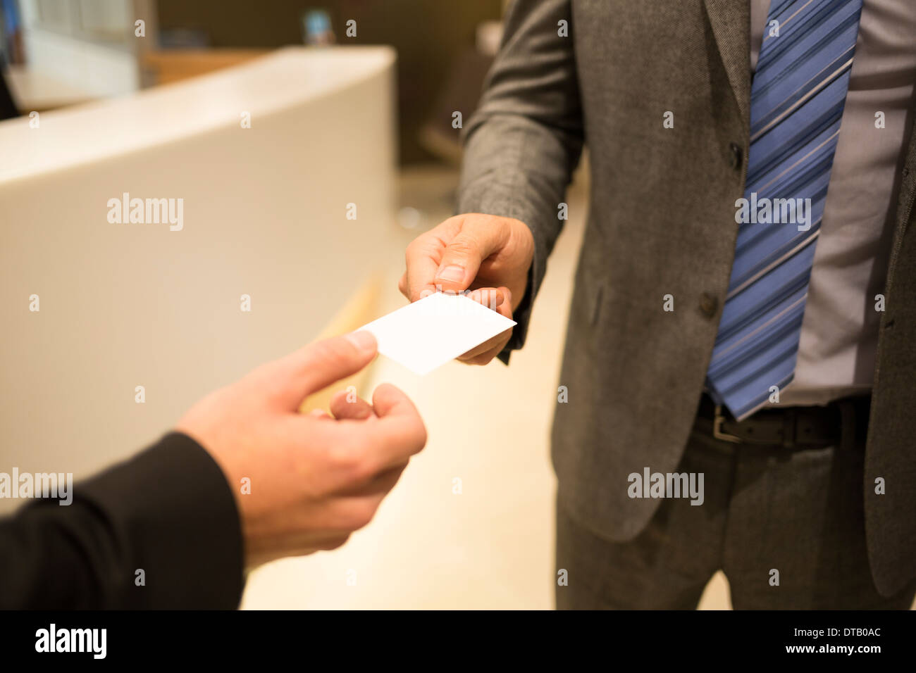 Closeup of two successful business executive exchanging business card Stock Photo