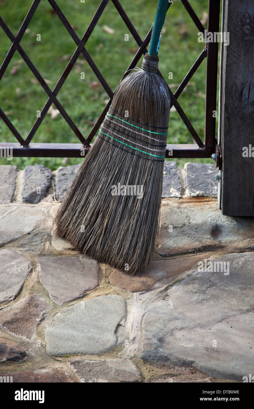Broom leaning near railing Stock Photo