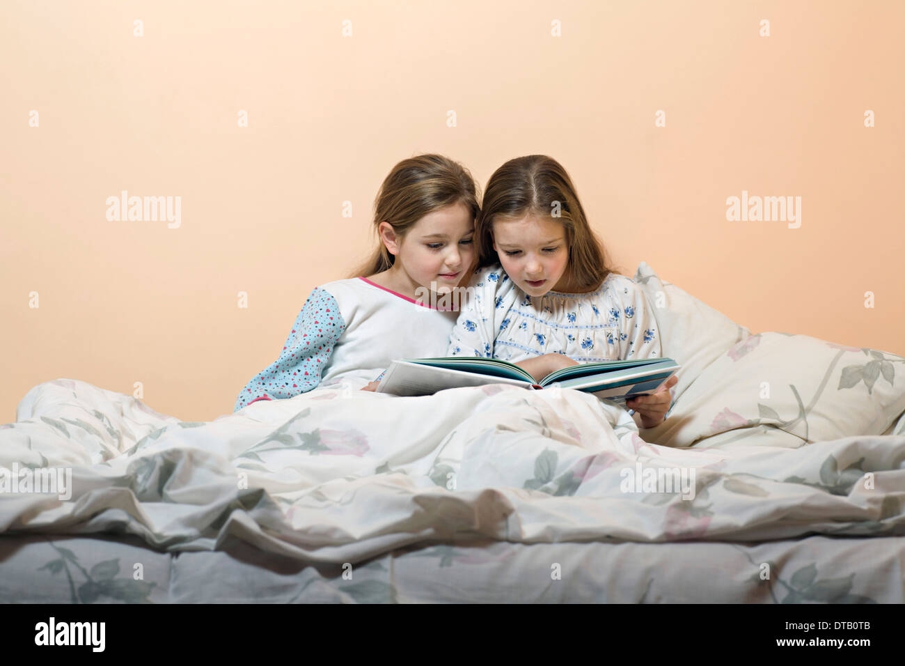 Girls reading story book Stock Photo