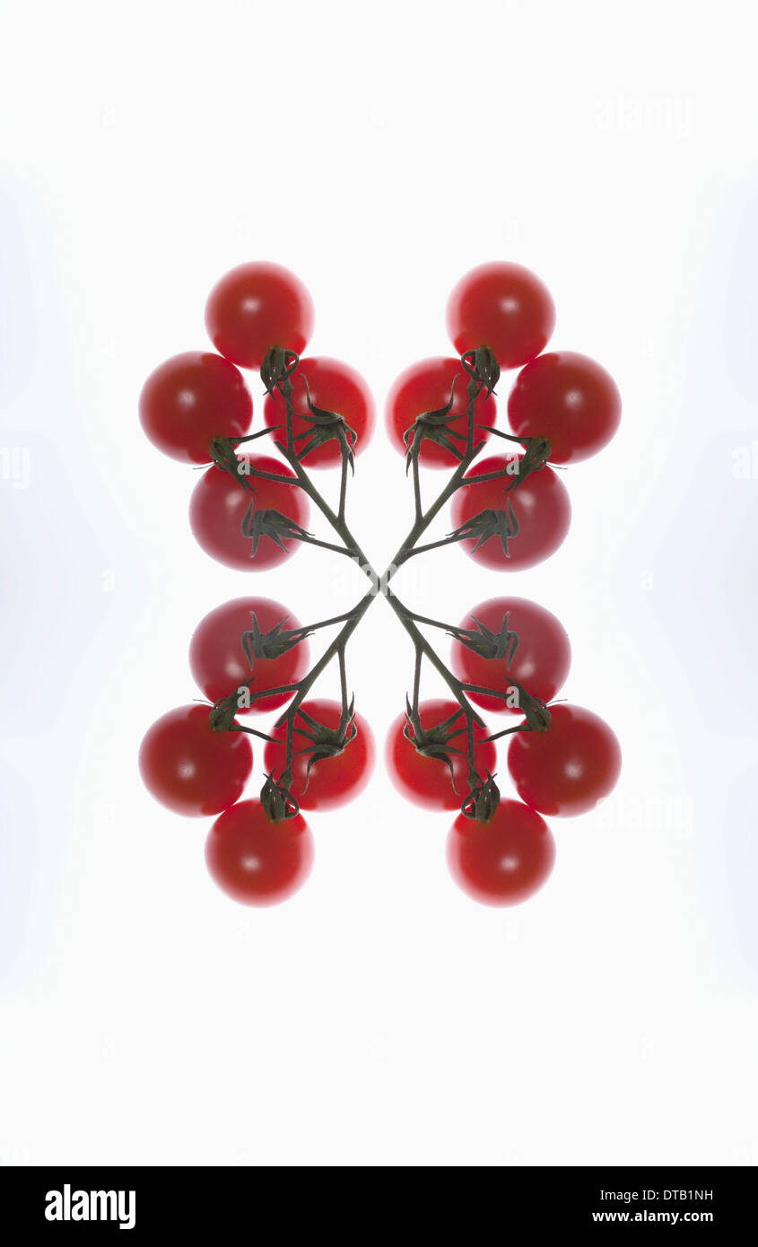 A digital composite of mirrored images of an arrangement of red currants Stock Photo