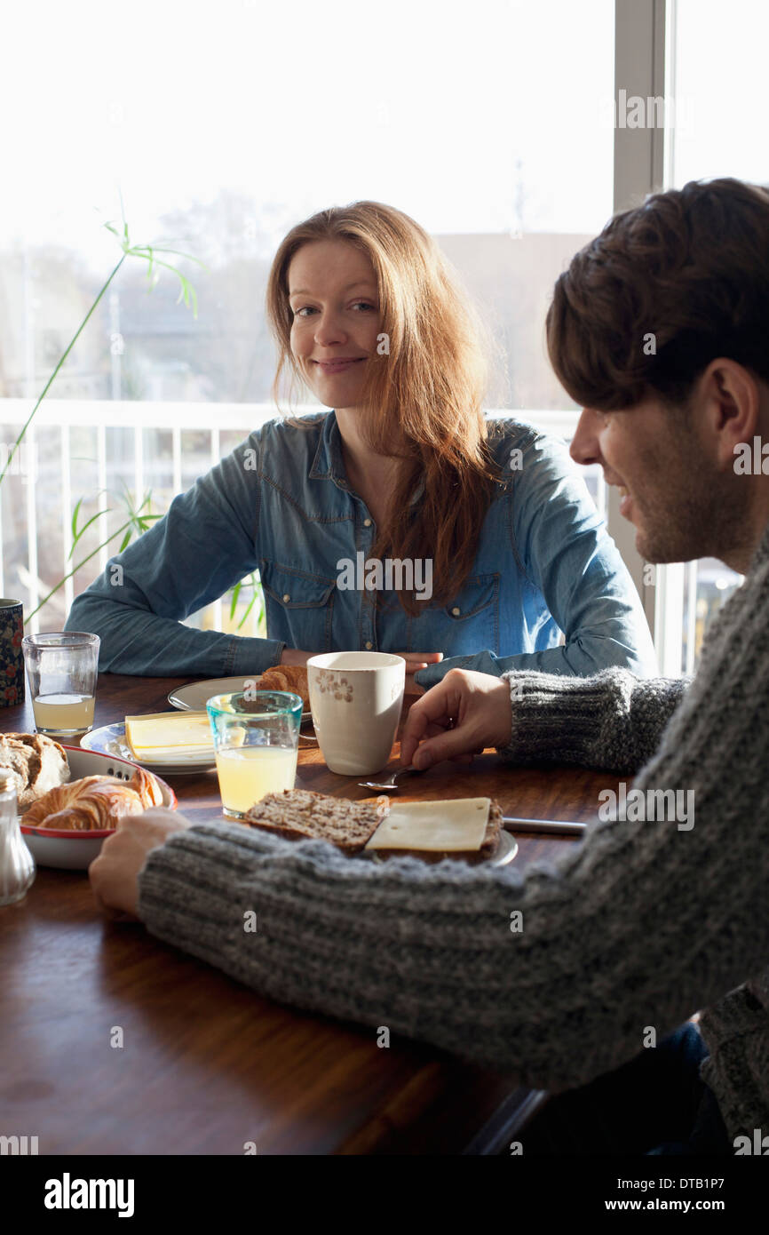 Couple having breakfast at dining table Stock Photo
