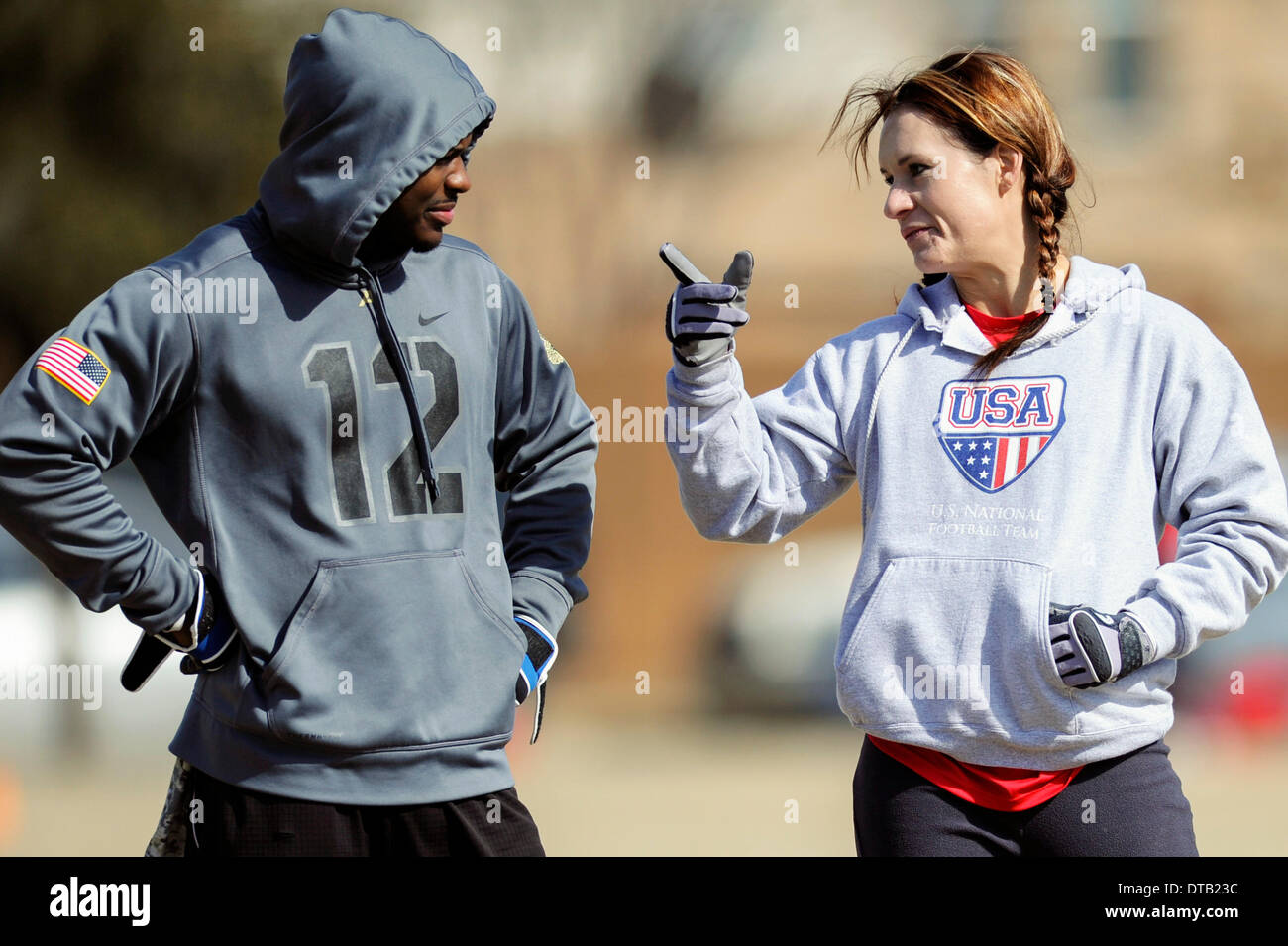 Feb. 13, 2014 - Allen, TX, United States of America - Jennifer Welter (right) visits with a teammate while waiting to participate in a drill during practice Thursday, February 13, 2014, in Allen, Texas. The 5-foot-2-inch, 130 pound Welter is the first woman to try out for a professional football team at a position other than kicker, she is trying to make the Texas Revolution of the Arena Football League, as a running back. Stock Photo