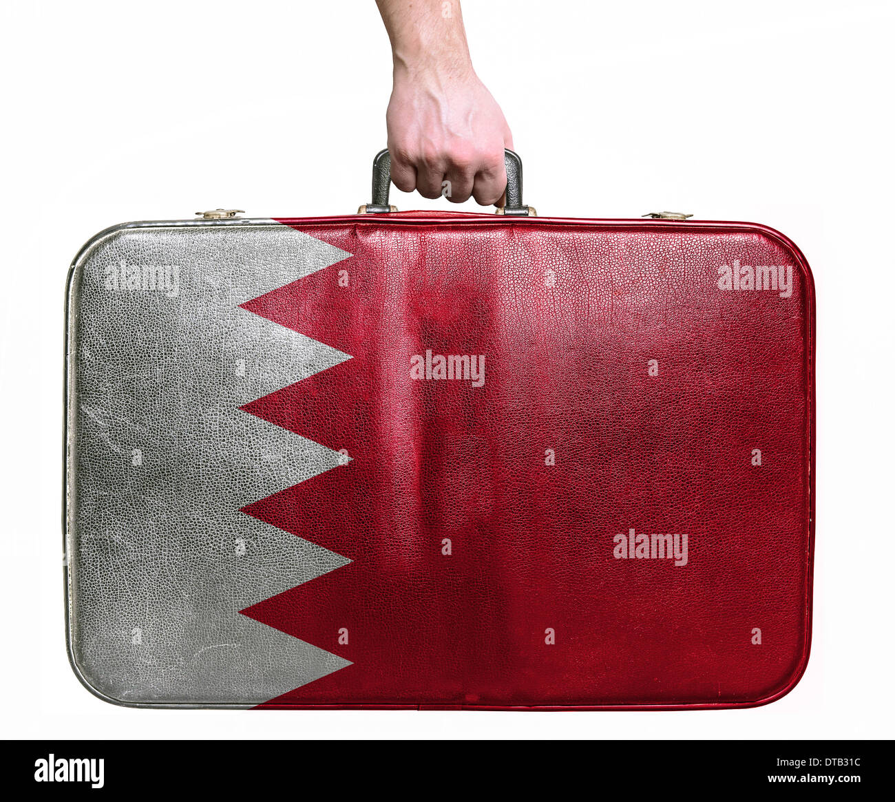 Tourist hand holding vintage leather travel bag with flag of Bahrain