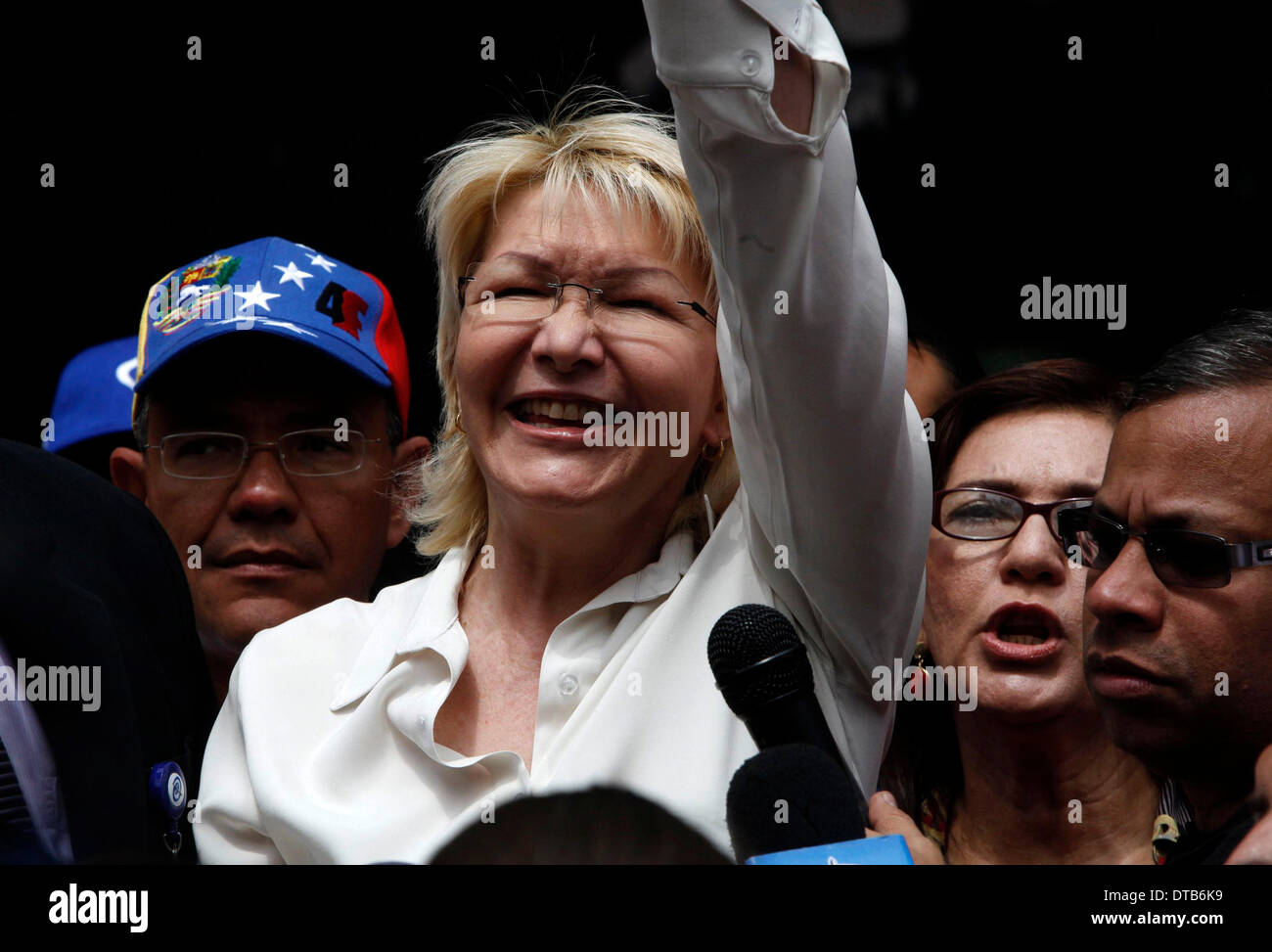 Caracas, Venezuela. 13th Feb, 2014. Venezuela's Attorney General Luisa Ortega Diaz (C) reacts during a demonstration in support of the Justice Department and against violence in Caracas, Venezuela, on Feb. 13, 2014. At least two people died and 23 others were injured as rival protests linked to Venezuela's deepening economic crisis exploded into violence on Wednesday. Credit:  AVN/Xinhua/Alamy Live News Stock Photo