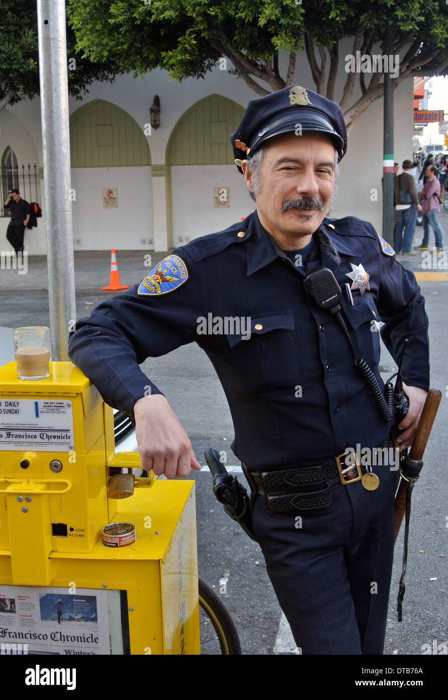 policeman in uniform poses for photographer on grant street in North Beach San Francisco Stock Photo