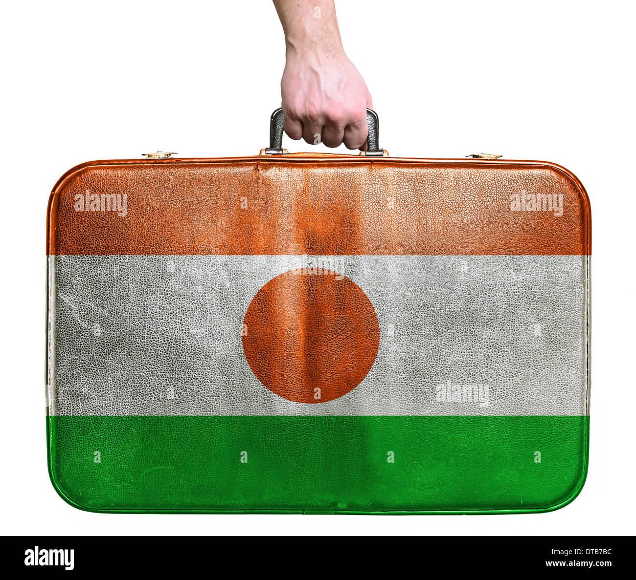 Tourist hand holding vintage leather travel bag with flag of Niger