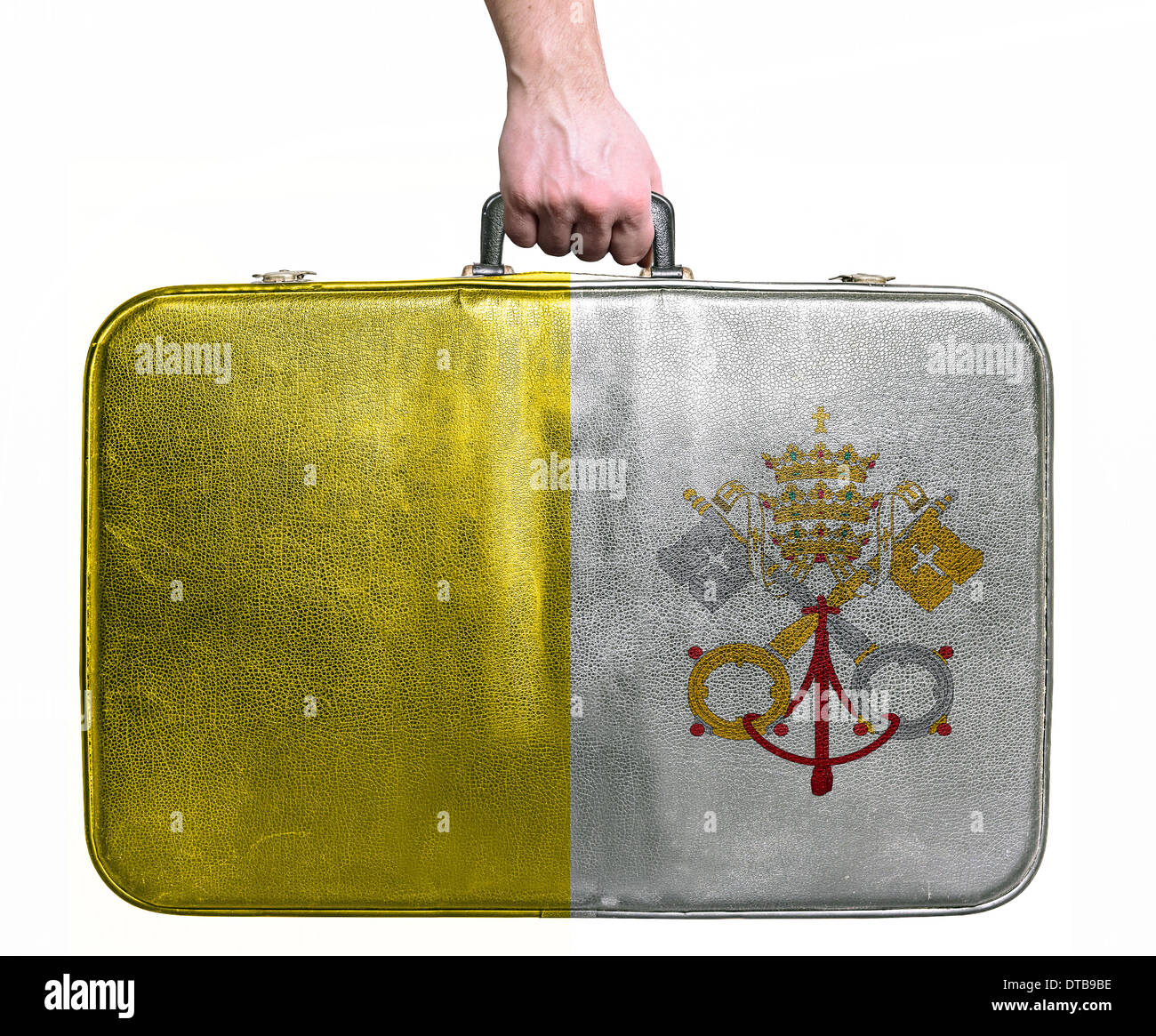 Tourist hand holding vintage leather travel bag with flag of Vatican