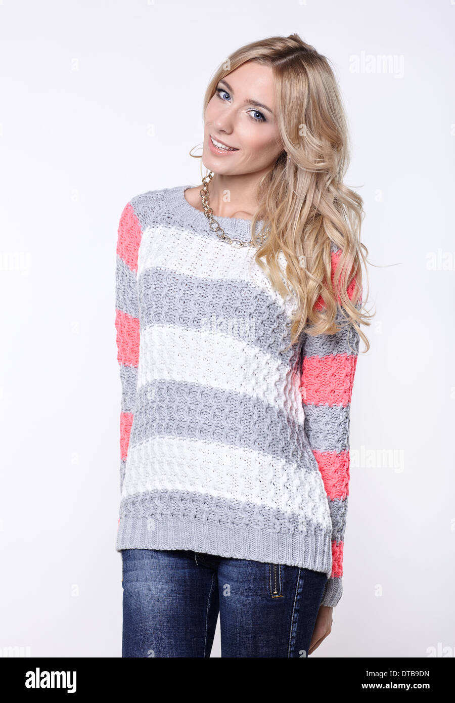 young beautiful blonde woman in jeans and sweater Stock Photo - Alamy