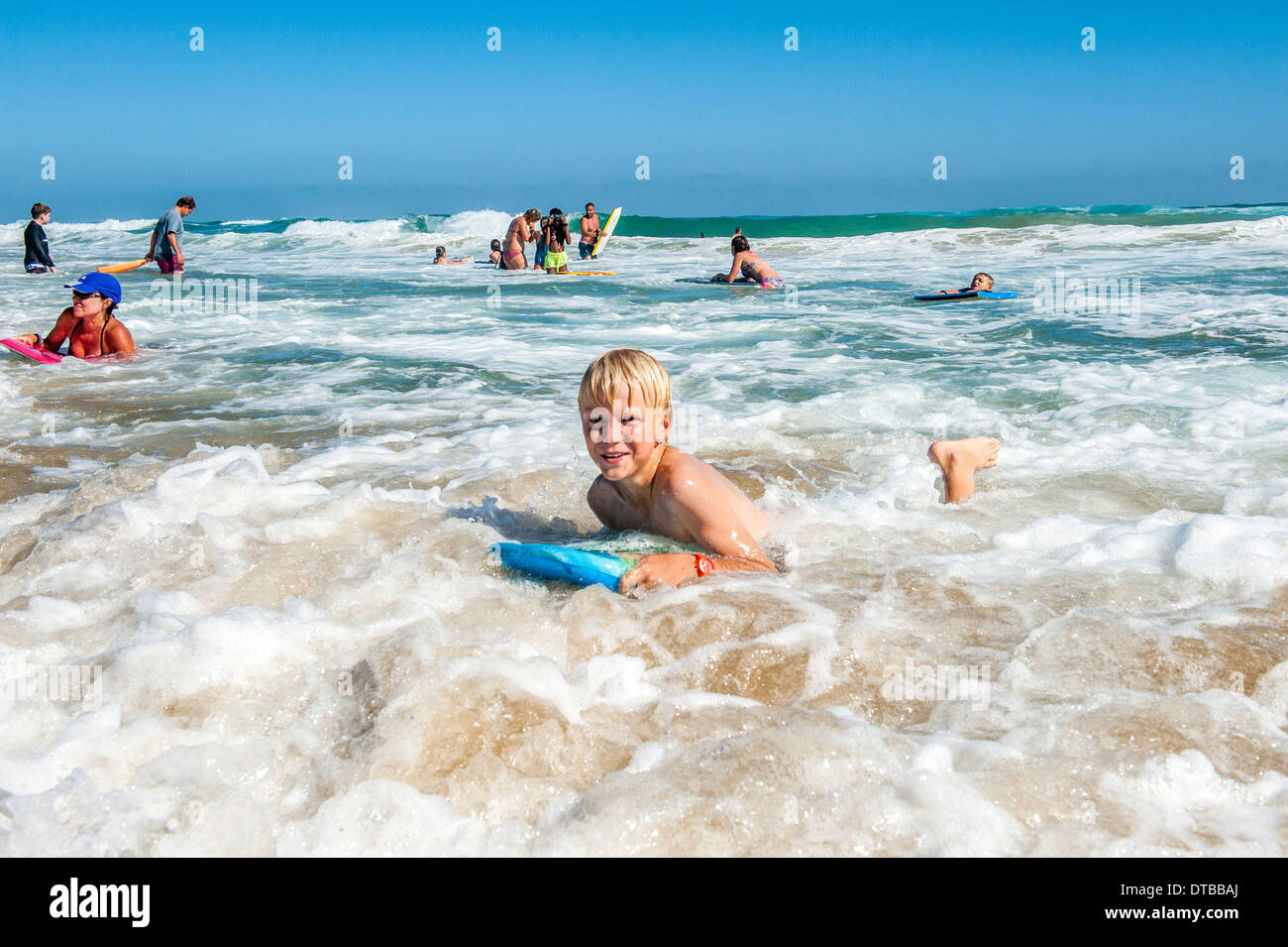 A boy enjoys body boarding the waves at Sedgefield, Eastern Cape, South Africa Stock Photo