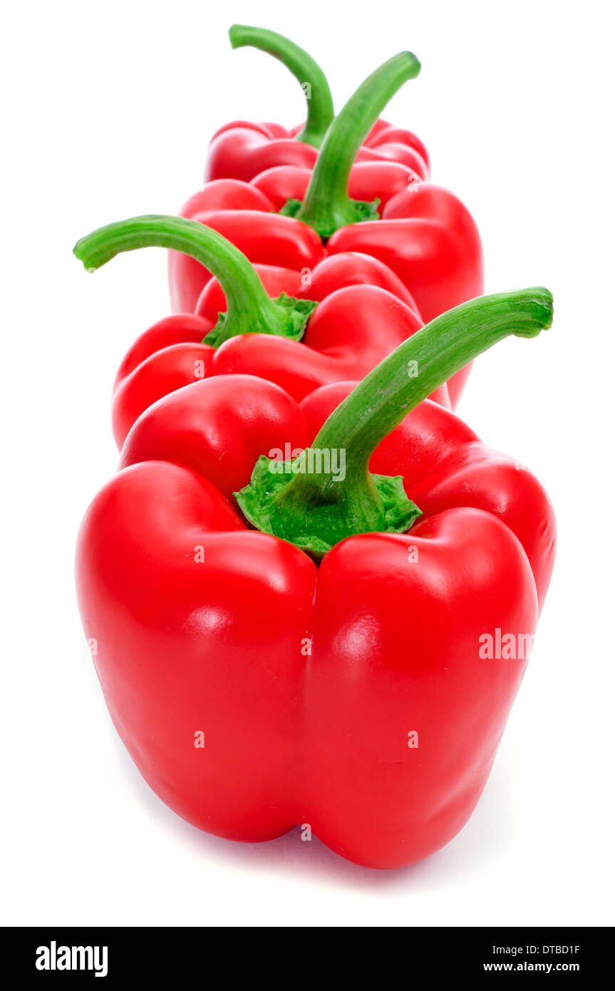 some red bell peppers on a white background Stock Photo - Alamy