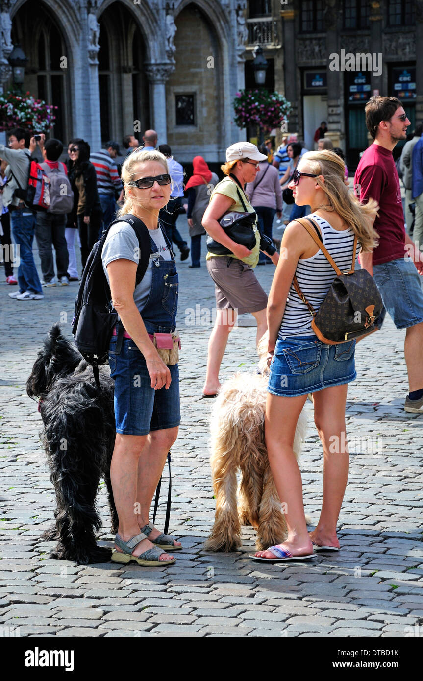 Brussels, Belgium. Two women with large dogs in the Grand Place Stock Photo