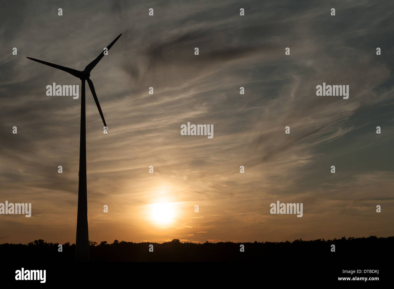 Nauen, Germany , wind turbine on a field in the evening sun Stock Photo