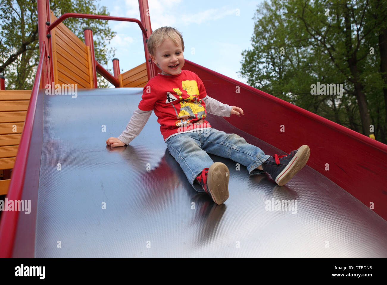 Berlin, Germany , a small child sliding down a slide Stock Photo