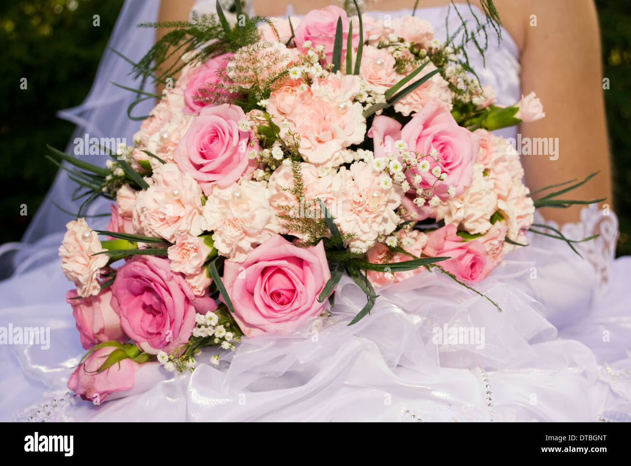 Bride hold the bouquet from pink roses and carnations Stock Photo - Alamy