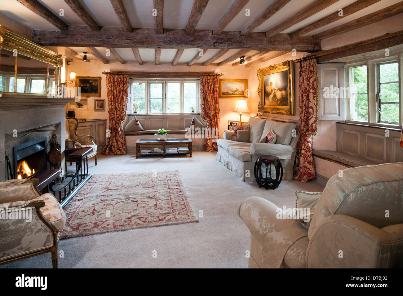 Large traditional beamed ceiling cottage sitting room. Stock Photo